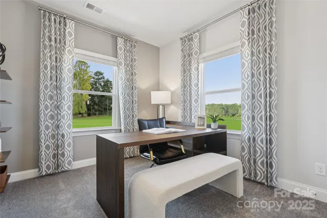 a room with furniture a window and a potted plant