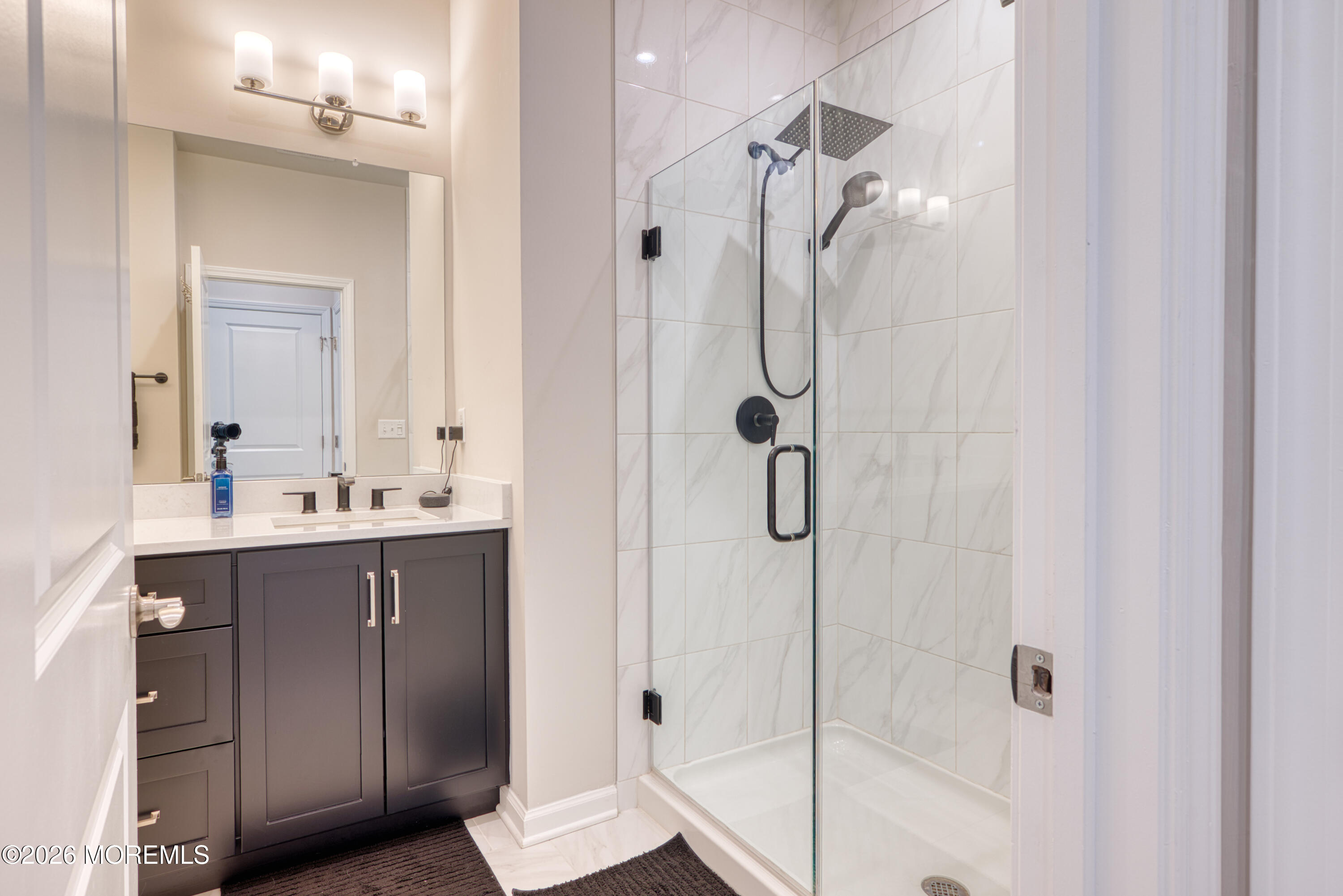 8 Laird Way Neptune, NJ 07753 - Photo 15 of 23 a bathroom with a shower sink and mirror