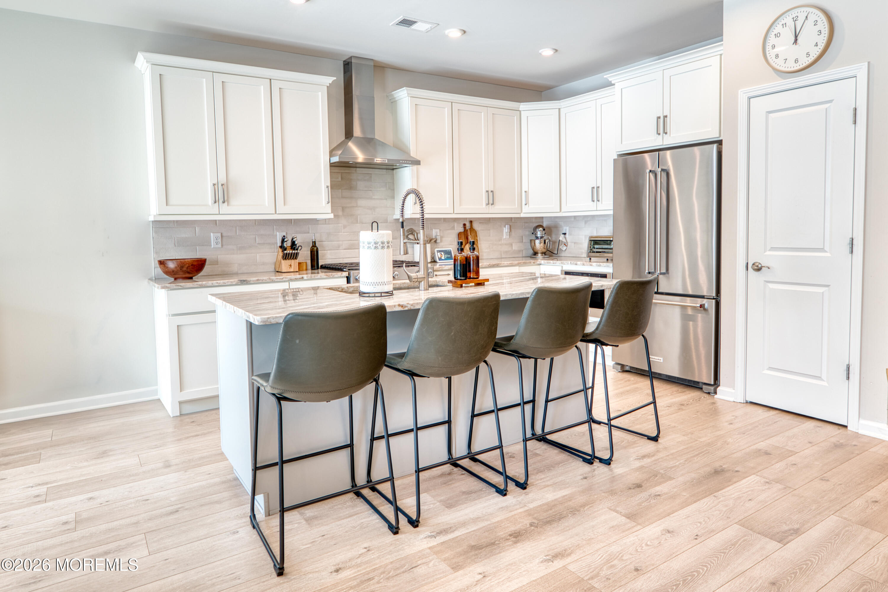 8 Laird Way Neptune, NJ 07753 - Photo 22 of 23 a kitchen with stainless steel appliances granite countertop a dining table chairs refrigerator and sink
