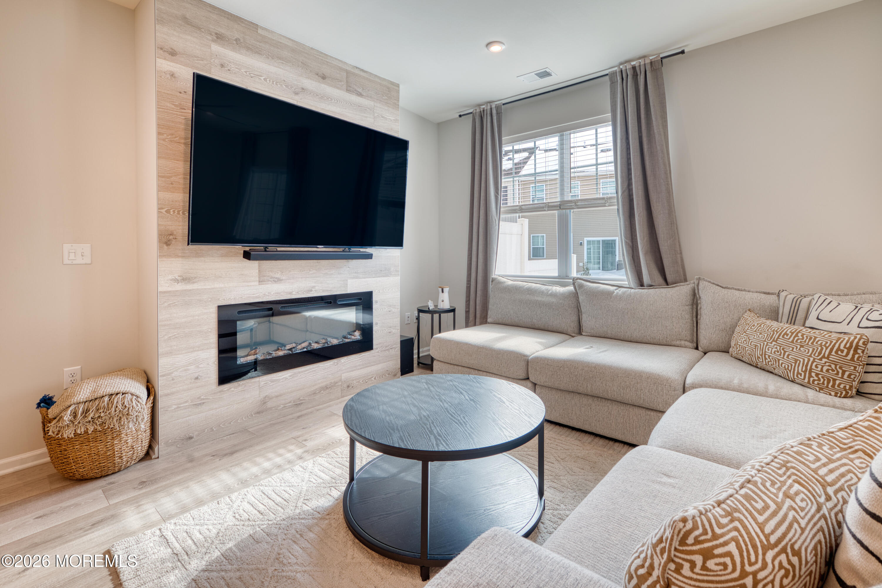 8 Laird Way Neptune, NJ 07753 - Photo 8 of 23 a living room with furniture a flat screen tv and a fireplace