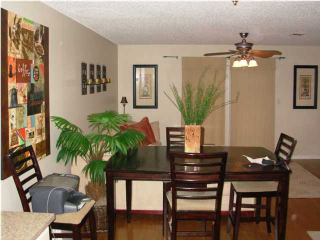 44 Berwick Circle, Unit 2 Shalimar, FL 32579 - Photo 3 of 12 a view of a dining room with furniture and wooden floor