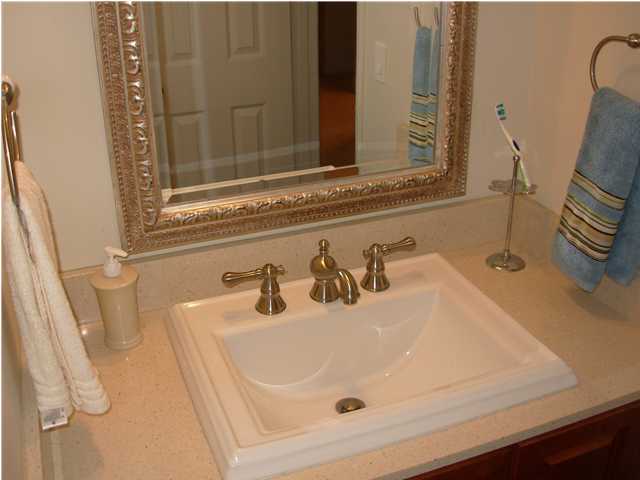 44 Berwick Circle, Unit 2 Shalimar, FL 32579 - Photo 9 of 12 a bathroom with a sink and a mirror