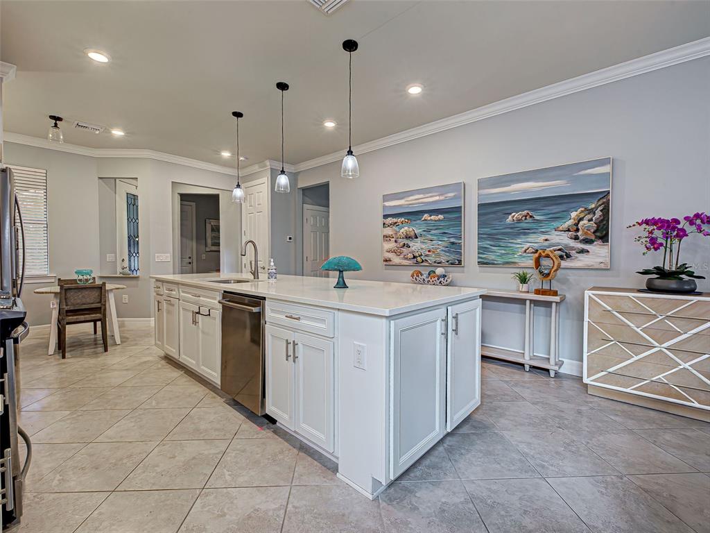 13836 Campoleone Street Venice, FL 34293 - Photo 12 of 99 a kitchen that has a lot of cabinets in it and appliances