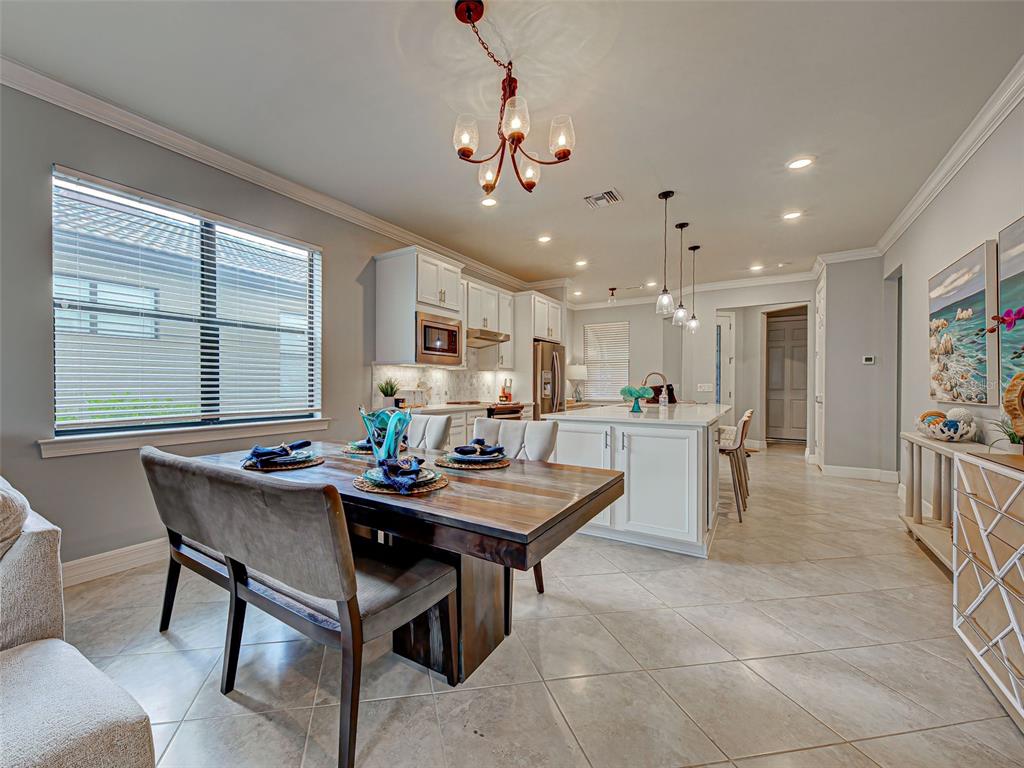 13836 Campoleone Street Venice, FL 34293 - Photo 16 of 99 a view of a dining room with furniture and a chandelier
