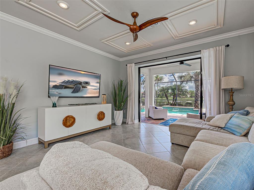 13836 Campoleone Street Venice, FL 34293 - Photo 20 of 99 a living room with furniture and a flat screen tv