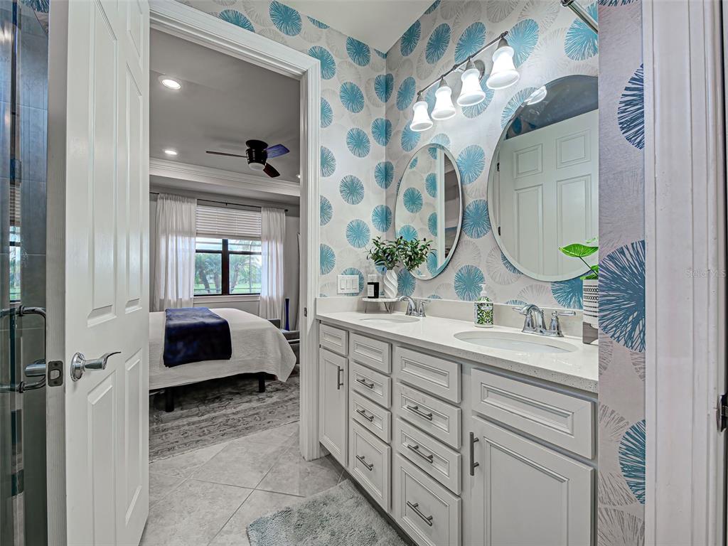 13836 Campoleone Street Venice, FL 34293 - Photo 27 of 99 a en suite bathroom with a double vanity sink and a mirror