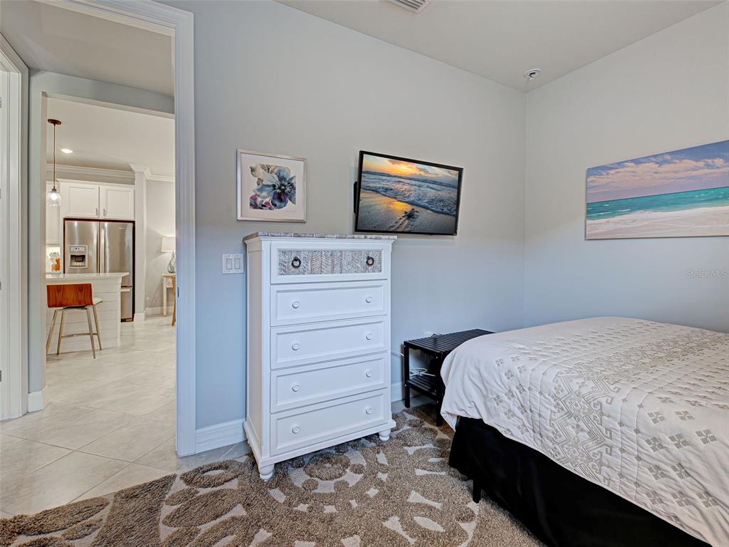 13836 Campoleone Street Venice, FL 34293 - Photo 33 of 99 a bedroom with a bed and a mirror