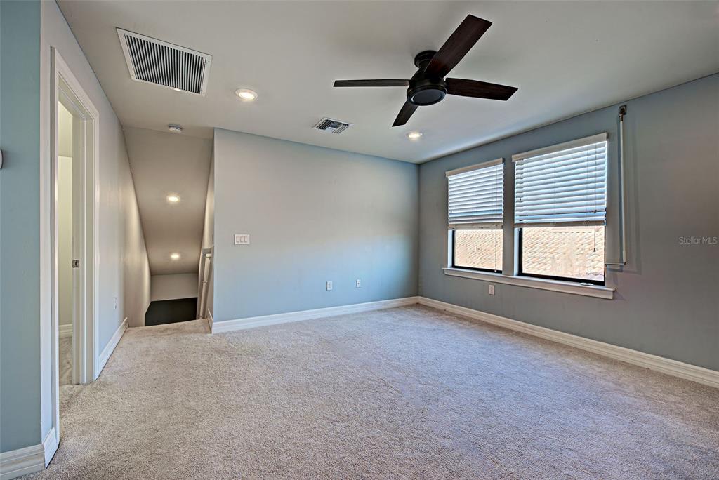 13836 Campoleone Street Venice, FL 34293 - Photo 36 of 99 a view of a livingroom with a ceiling fan and window