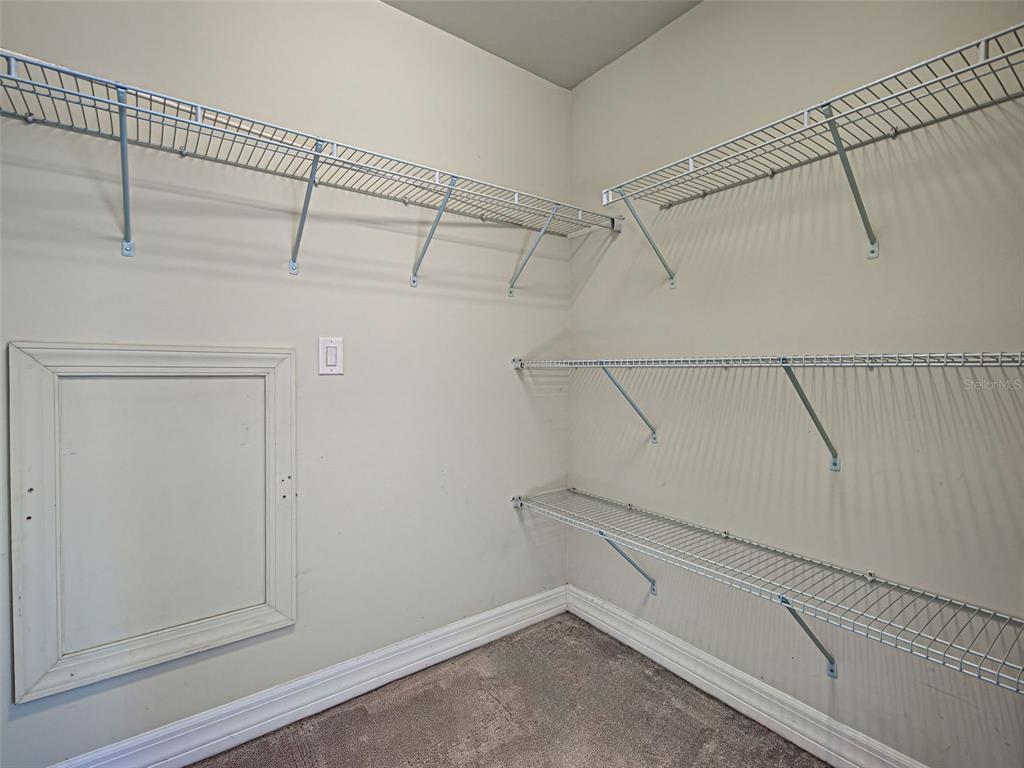 13836 Campoleone Street Venice, FL 34293 - Photo 39 of 99 a view of walk in closet with empty racks