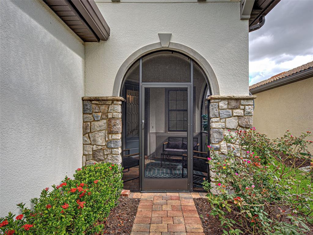 13836 Campoleone Street Venice, FL 34293 - Photo 5 of 99 a front view of a house with a garden