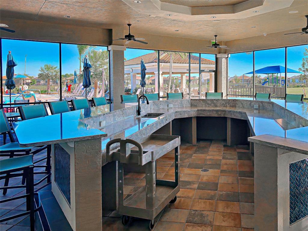 13836 Campoleone Street Venice, FL 34293 - Photo 60 of 99 a kitchen with stainless steel appliances granite countertop a stove and a view of dining room