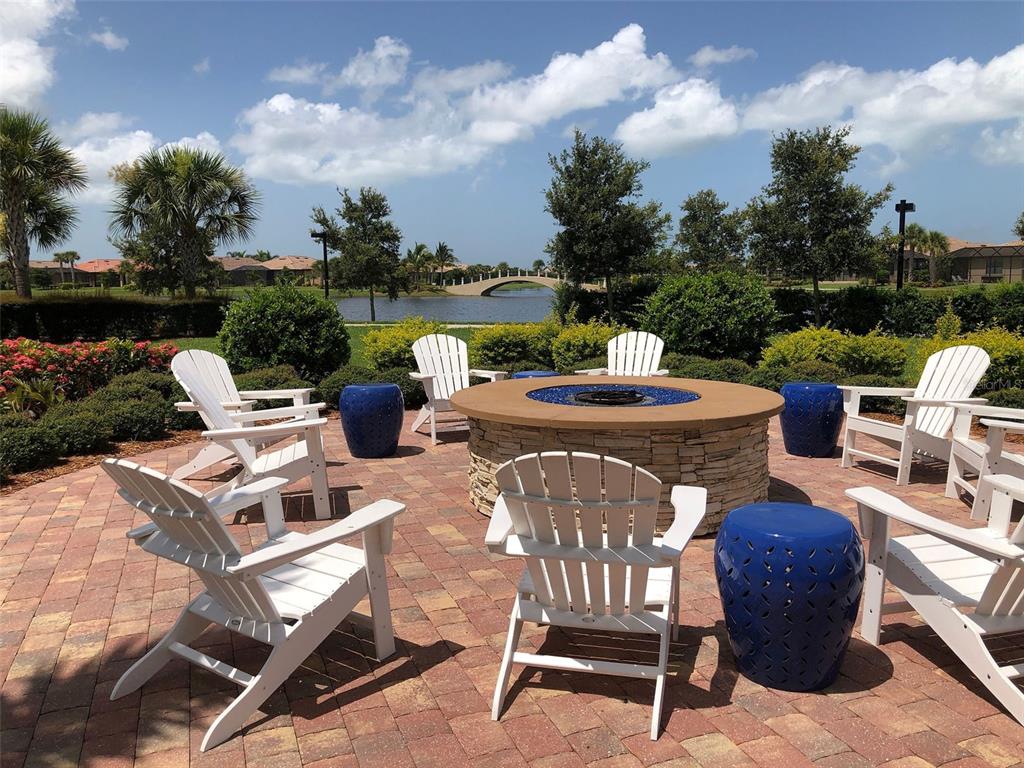 13836 Campoleone Street Venice, FL 34293 - Photo 62 of 99 a view of a patio with table and chairs and a fire pit