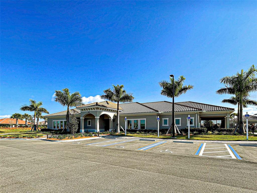 13836 Campoleone Street Venice, FL 34293 - Photo 63 of 99 a front view of a house with a garden and parking