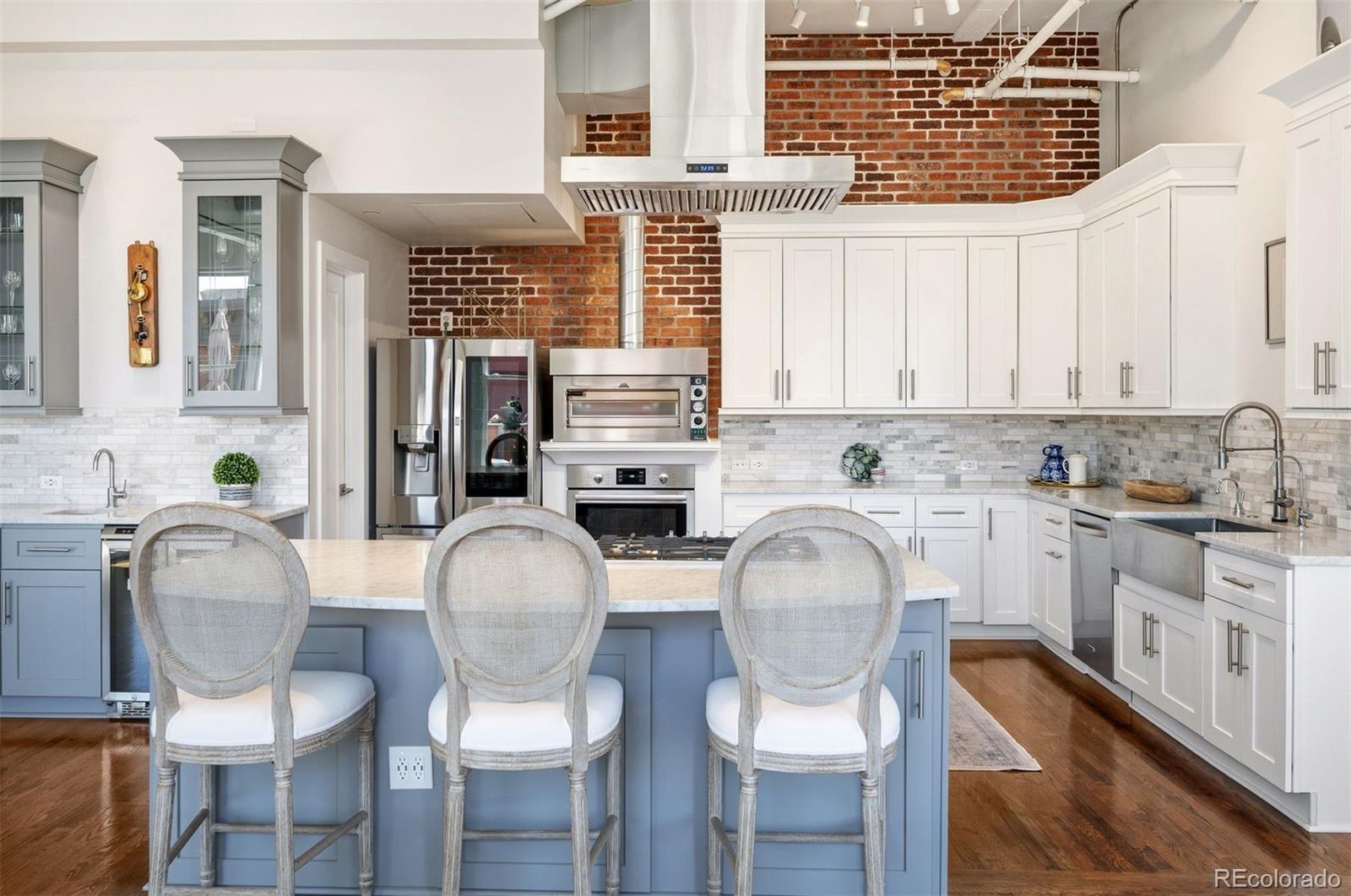 1501 Wazee Street, Unit 4B Denver, CO 80202 - Photo 14 of 49 a kitchen with stainless steel appliances granite countertop a dining table chairs and a window