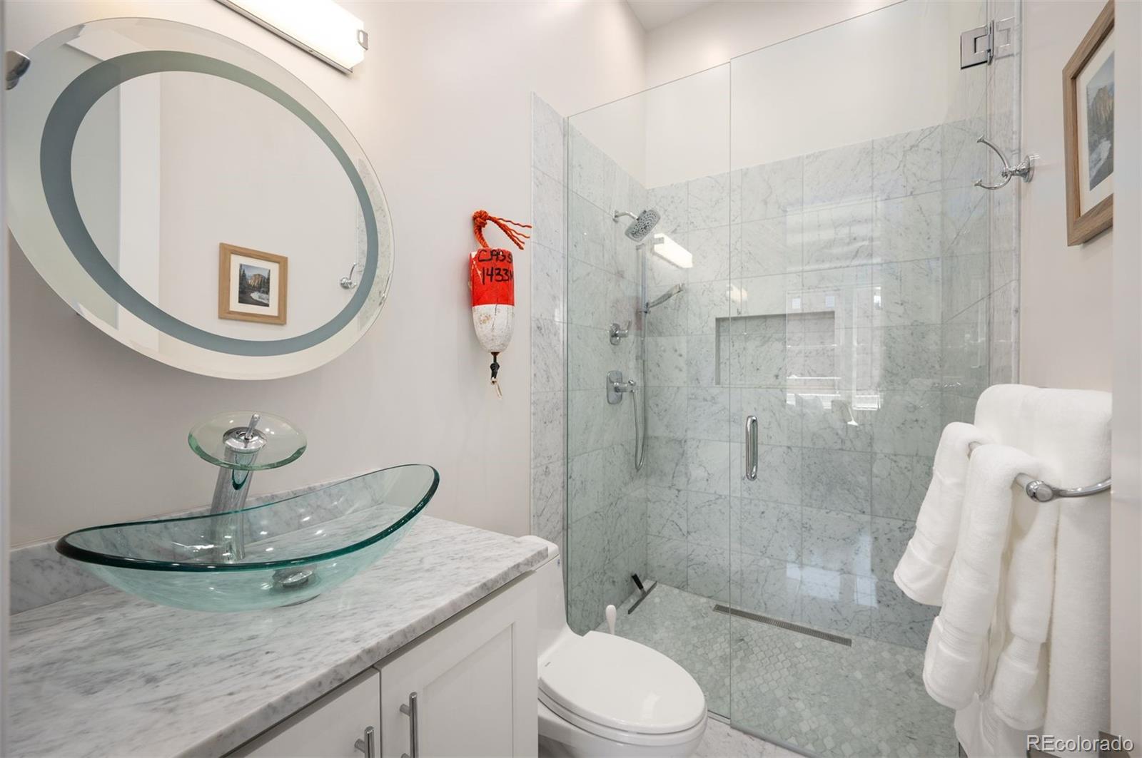 1501 Wazee Street, Unit 4B Denver, CO 80202 - Photo 21 of 49 a bathroom with a toilet a sink and mirror