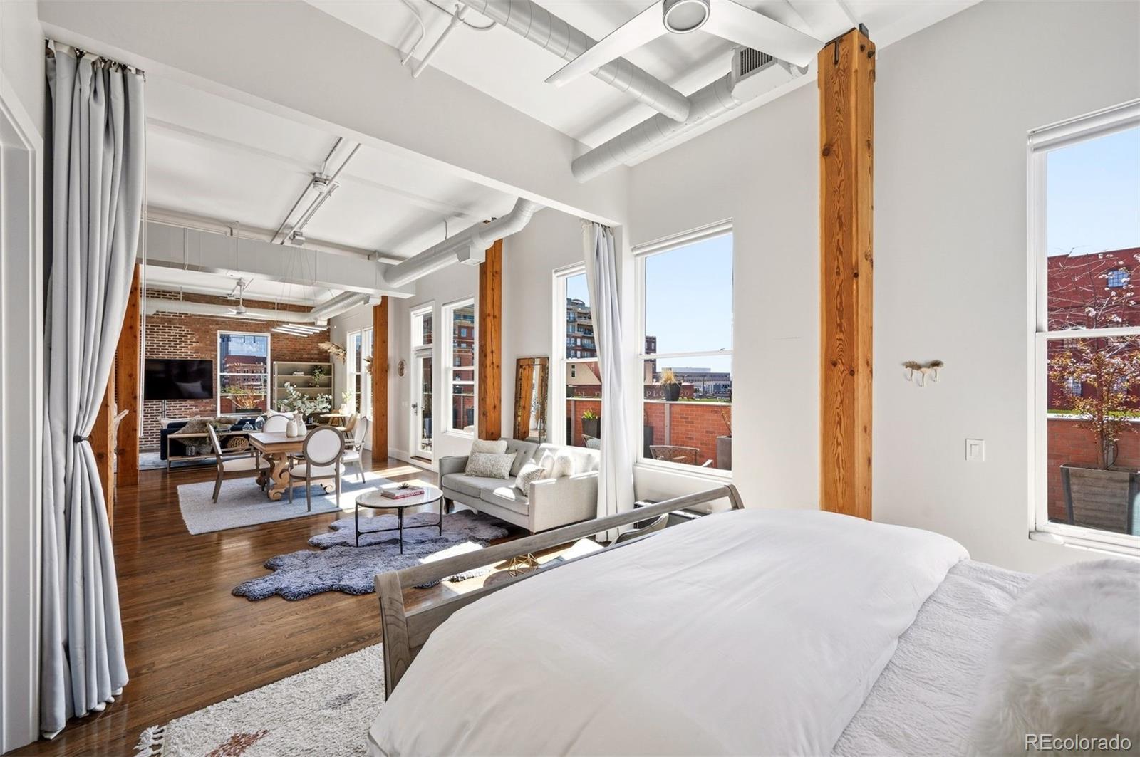 1501 Wazee Street, Unit 4B Denver, CO 80202 - Photo 4 of 49 a bedroom with a bed couch and large window with outer view