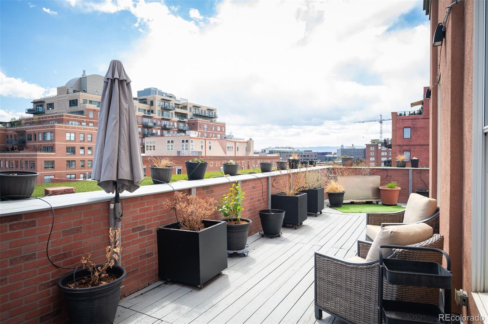 1501 Wazee Street, Unit 4B Denver, CO 80202 - Photo 46 of 49 a view of roof deck with seating space and barbeque oven