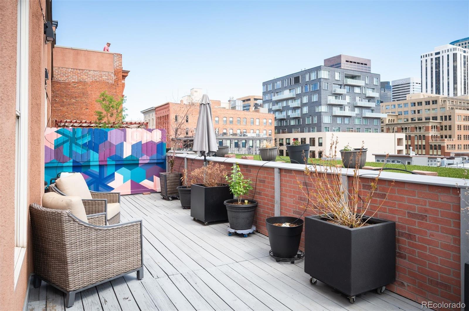 1501 Wazee Street, Unit 4B Denver, CO 80202 - Photo 48 of 49 a view of roof deck with seating space and potted plants