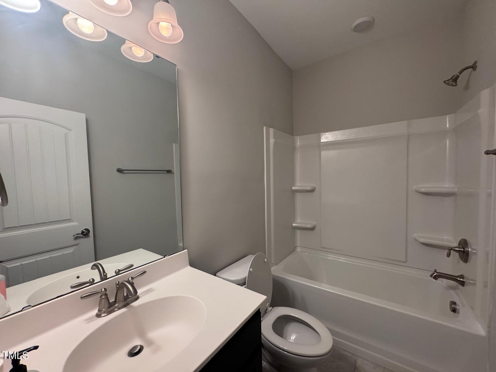 8008 Reedybrook Crossing Apex, NC 27523 - Photo 12 of 27 a bathroom with a sink a toilet and shower