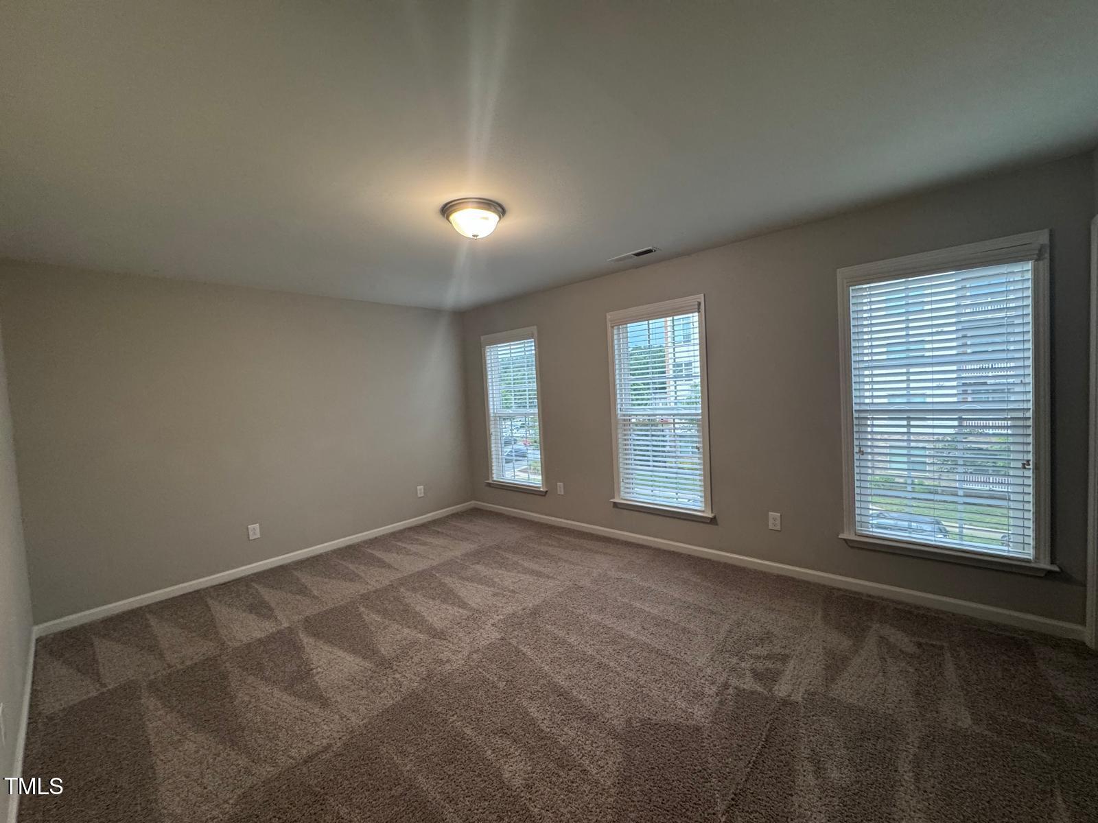8008 Reedybrook Crossing Apex, NC 27523 - Photo 17 of 27 an empty room with windows