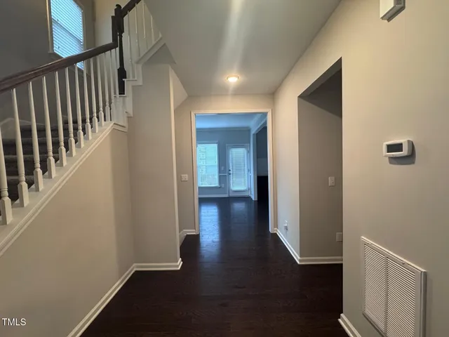 a view of hallway with wooden floor