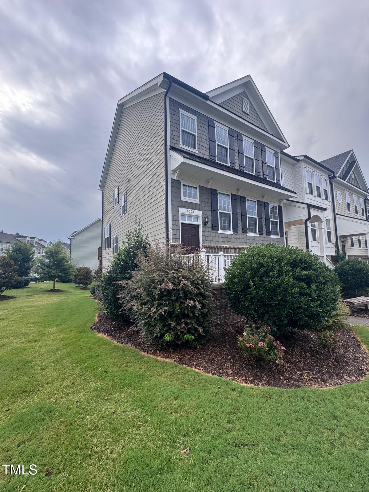 8008 Reedybrook Crossing Apex, NC 27523 - Photo 2 of 27 a front view of a house with garden