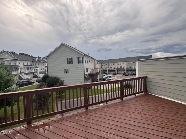 a view of a house with wooden deck