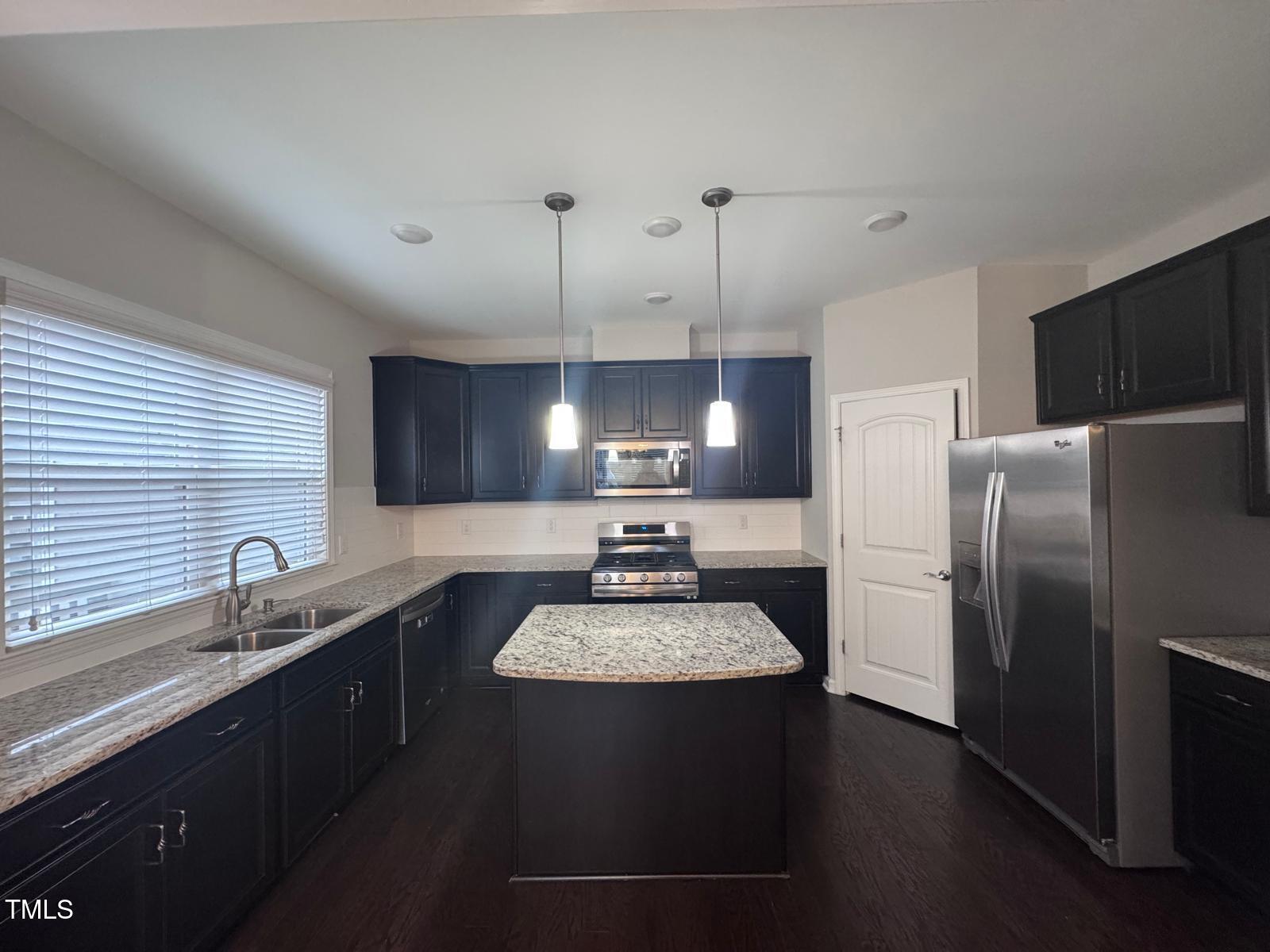 8008 Reedybrook Crossing Apex, NC 27523 - Photo 6 of 27 a kitchen with a refrigerator a sink dishwasher a stove and a refrigerator