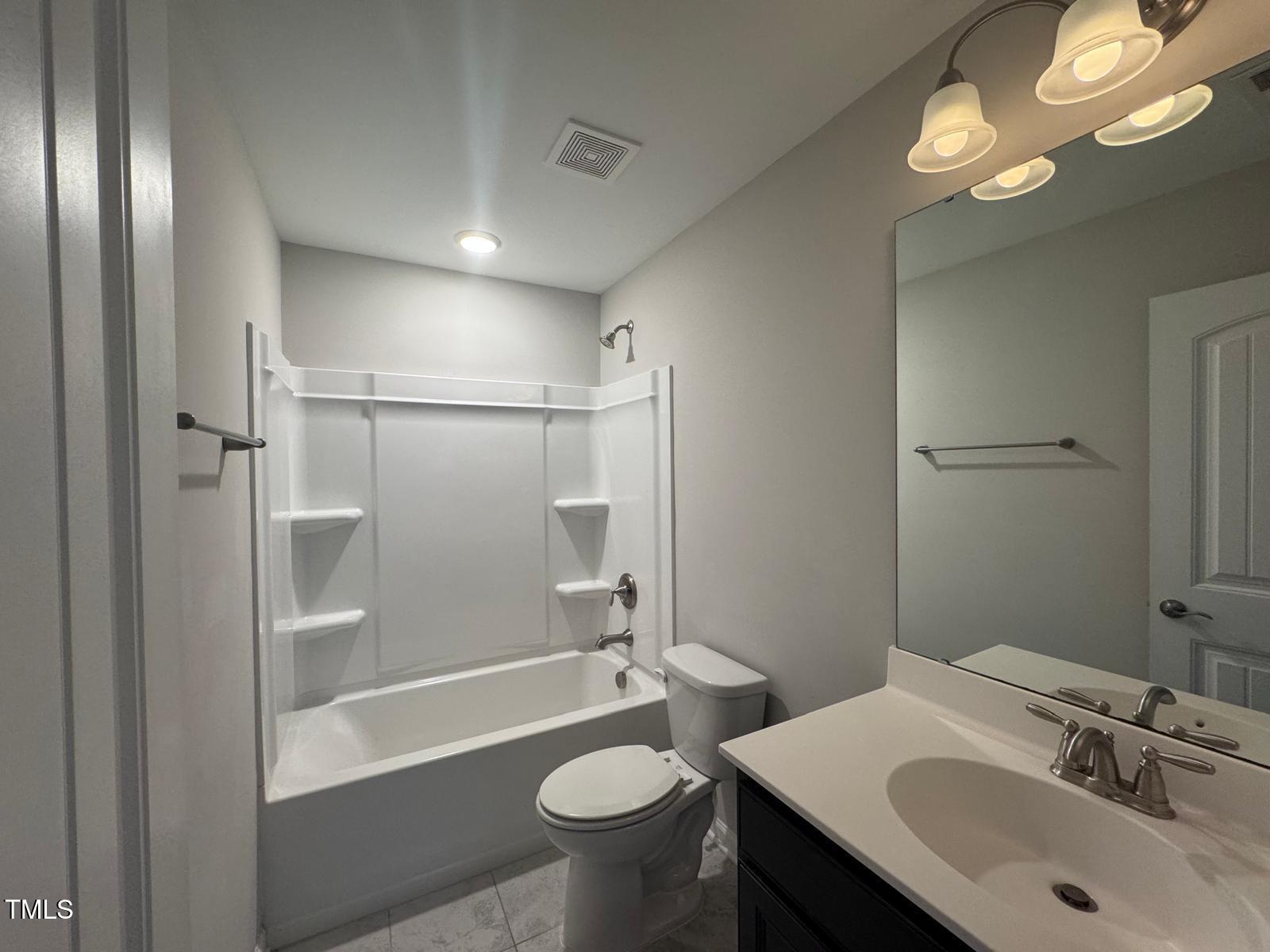 8008 Reedybrook Crossing Apex, NC 27523 - Photo 7 of 27 a bathroom with a sink a toilet and shower