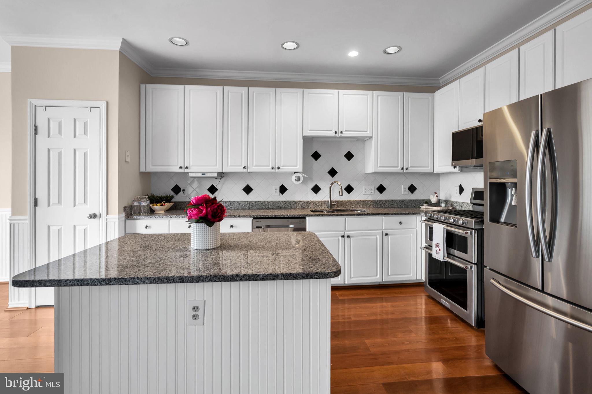 21644 Frame Square Broadlands, VA 20148 - Photo 12 of 38 a kitchen with stainless steel appliances granite countertop a refrigerator sink and cabinets
