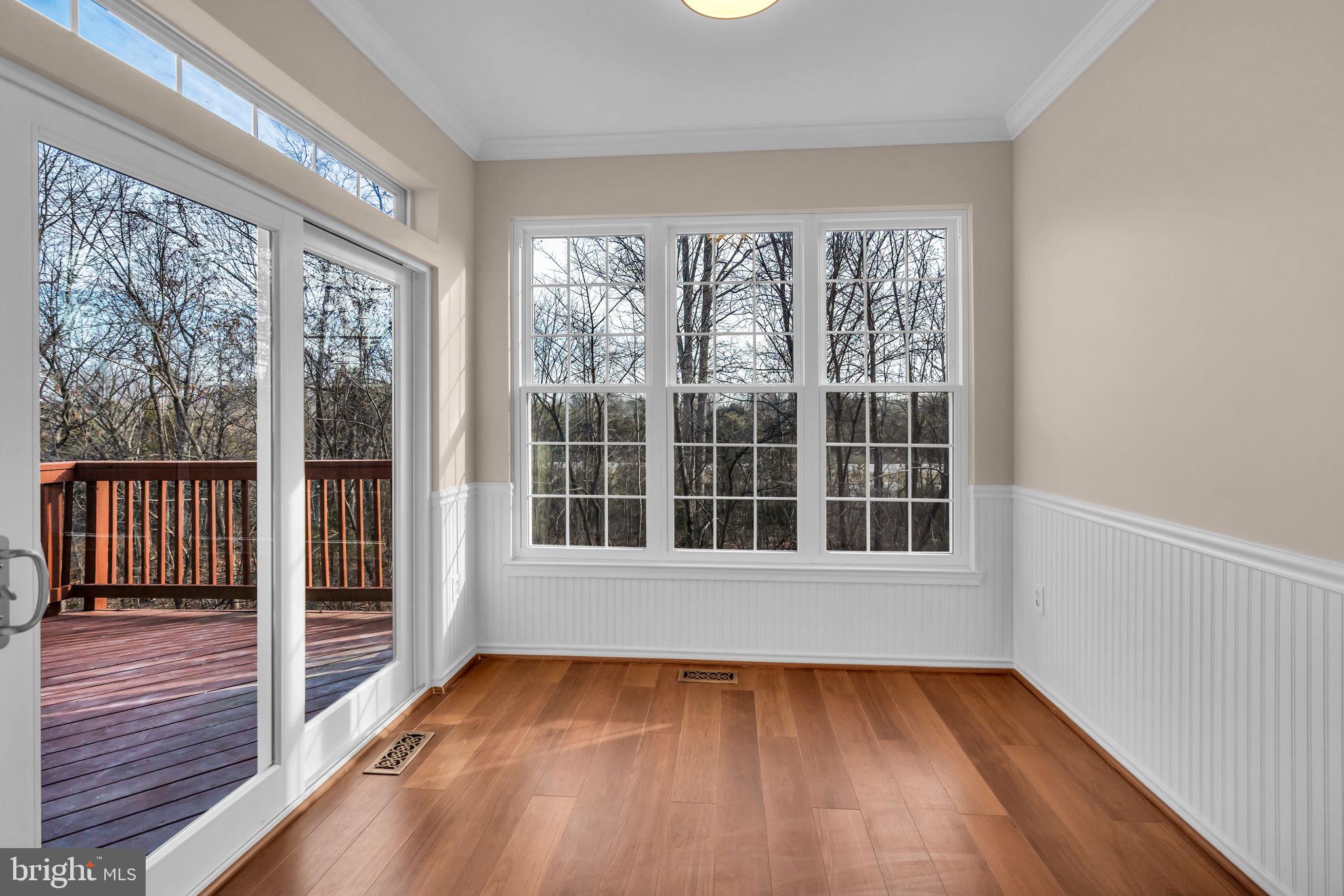 21644 Frame Square Broadlands, VA 20148 - Photo 13 of 38 a view of an empty room with wooden floor and a window
