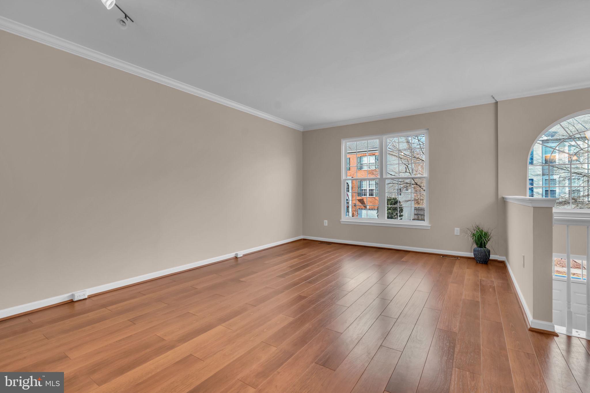 21644 Frame Square Broadlands, VA 20148 - Photo 5 of 38 an empty room with wooden floor and windows