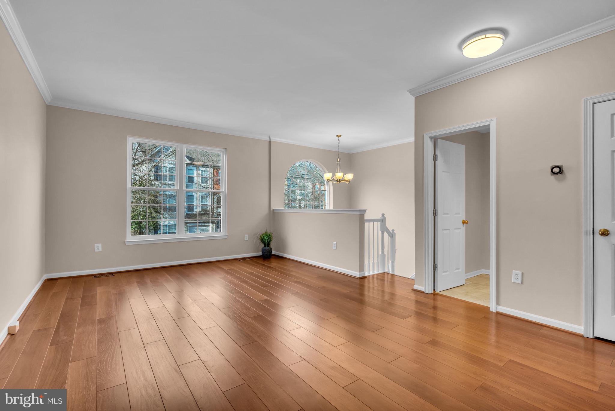 21644 Frame Square Broadlands, VA 20148 - Photo 6 of 38 an empty room with wooden floor and windows