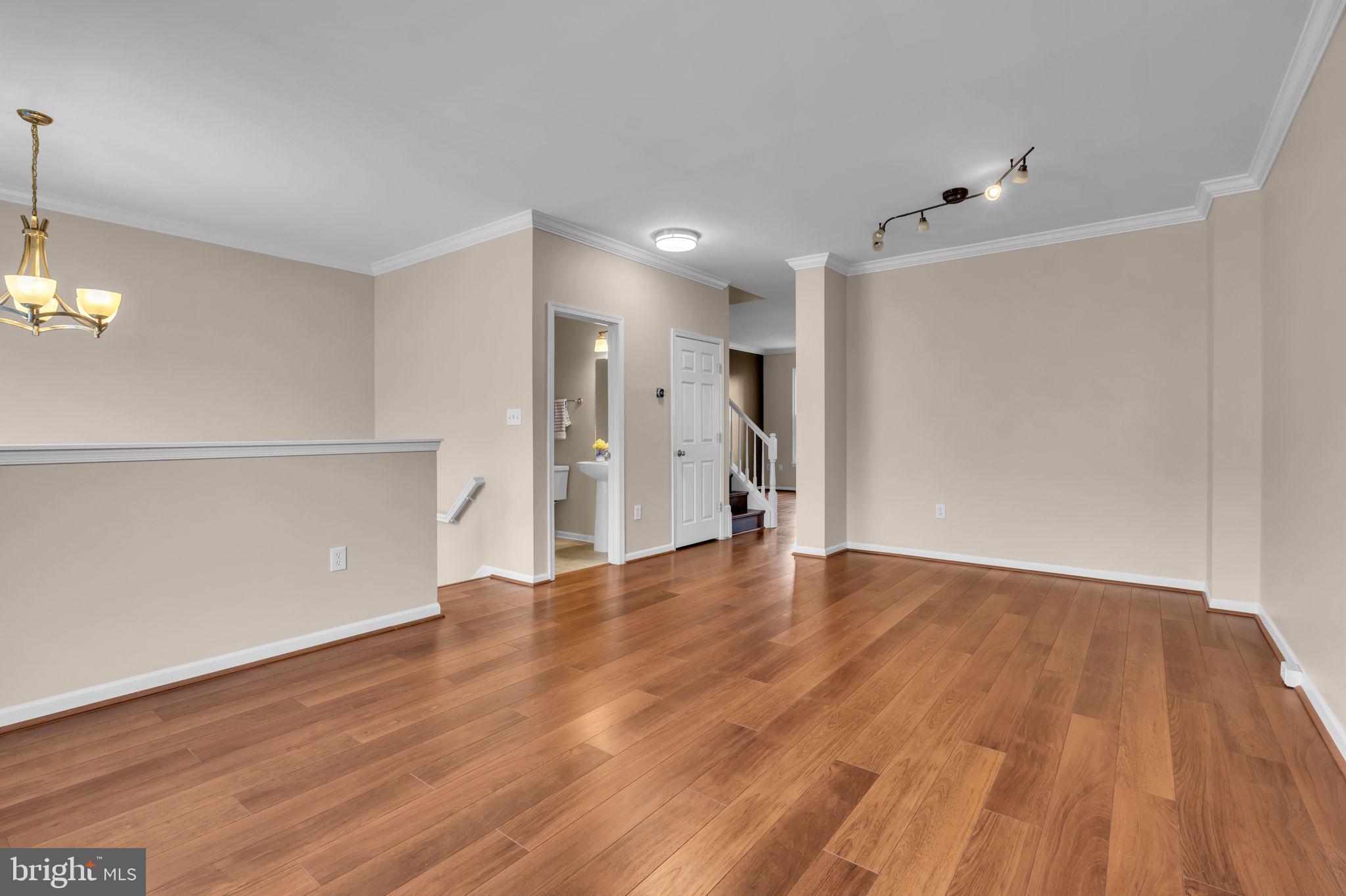 21644 Frame Square Broadlands, VA 20148 - Photo 7 of 38 a view of an empty room with wooden floor and a window