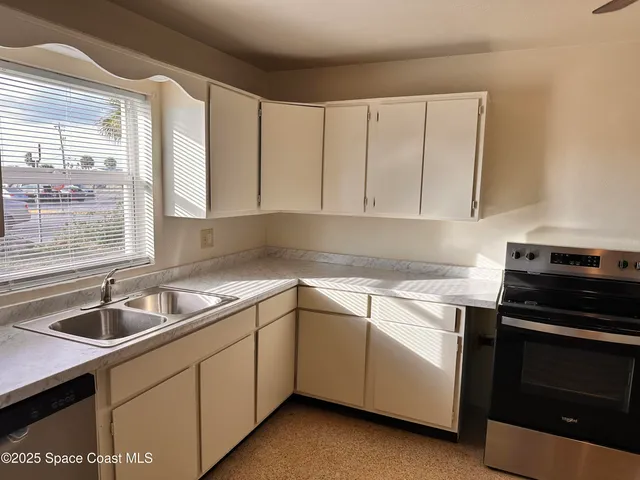 a kitchen that has a sink and a stove