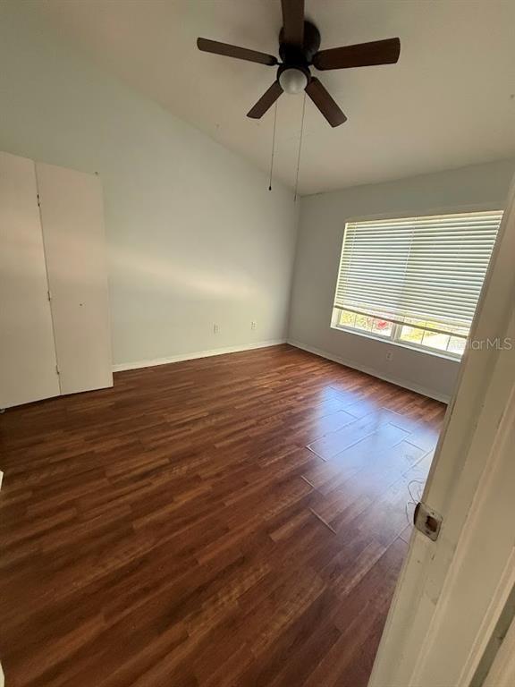 1567 Blue Magnolia Road Brandon, FL 33510 - Photo 22 of 23 an empty room with wooden floor fan and windows