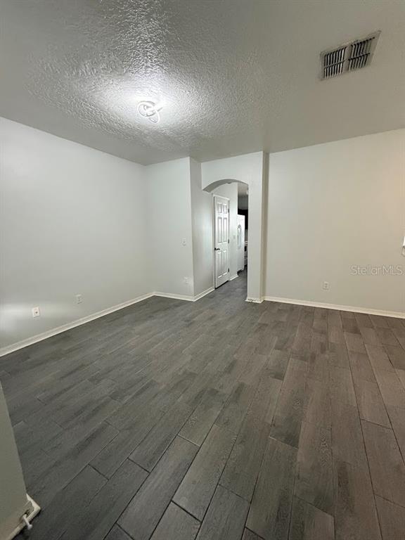 1567 Blue Magnolia Road Brandon, FL 33510 - Photo 3 of 23 an empty room with wooden floor & windows