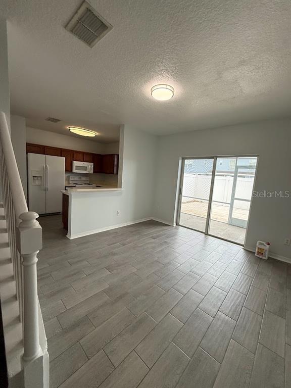 1567 Blue Magnolia Road Brandon, FL 33510 - Photo 6 of 23 an empty room with windows and refrigerator