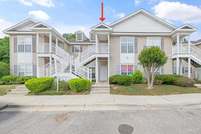a front view of a brick house with a yard