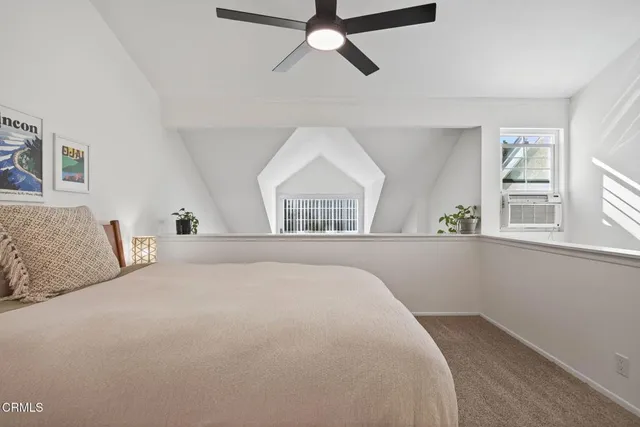 a spacious bedroom with a bed and a window