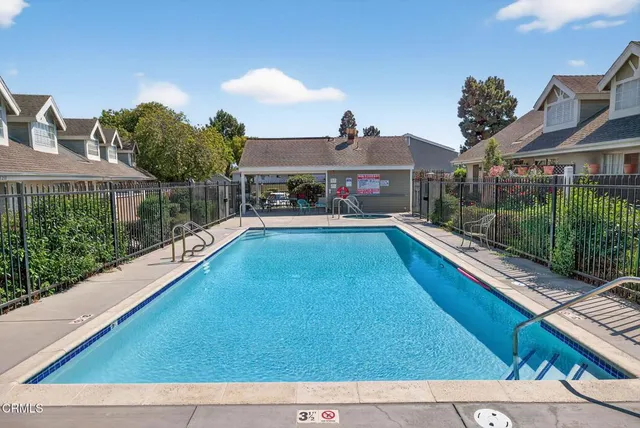 a view of a house with backyard porch and sitting area