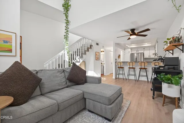 a living room with furniture ceiling fan and a rug