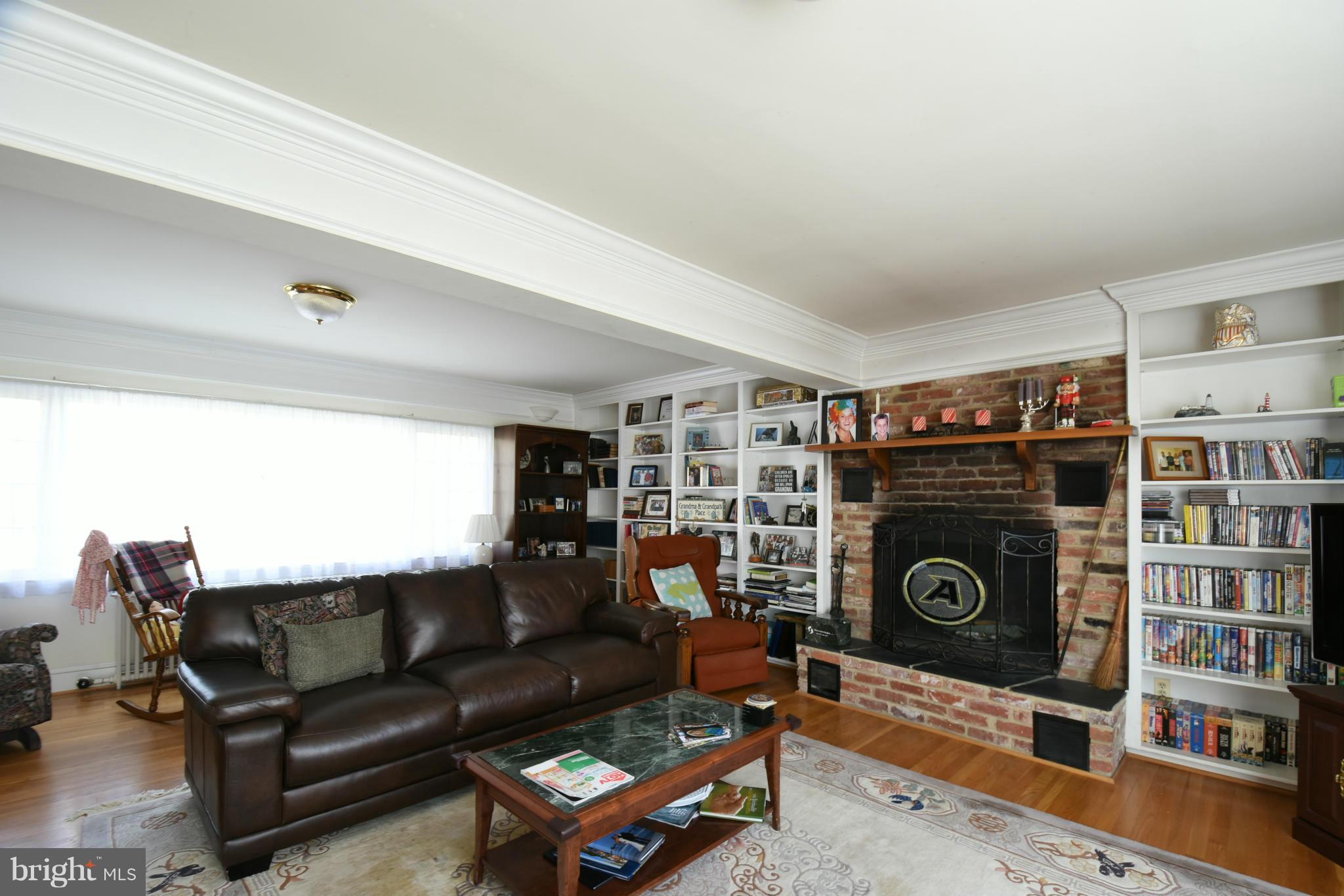5911 Chesterbrook Road McLean, VA 22101 - Photo 11 of 28 a living room with furniture a flat screen tv and a fireplace