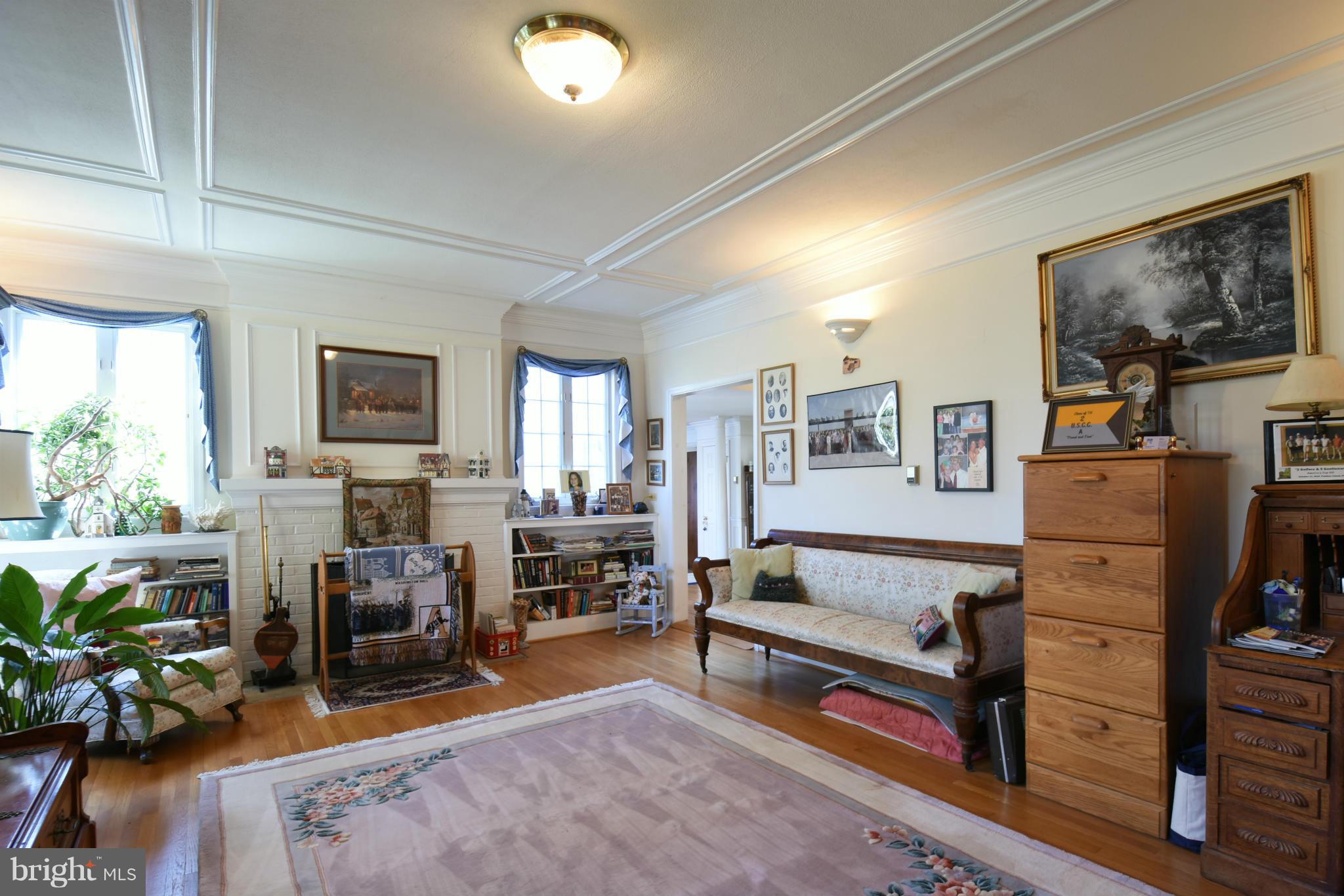 5911 Chesterbrook Road McLean, VA 22101 - Photo 3 of 28 a living room with furniture a fireplace and a potted plant