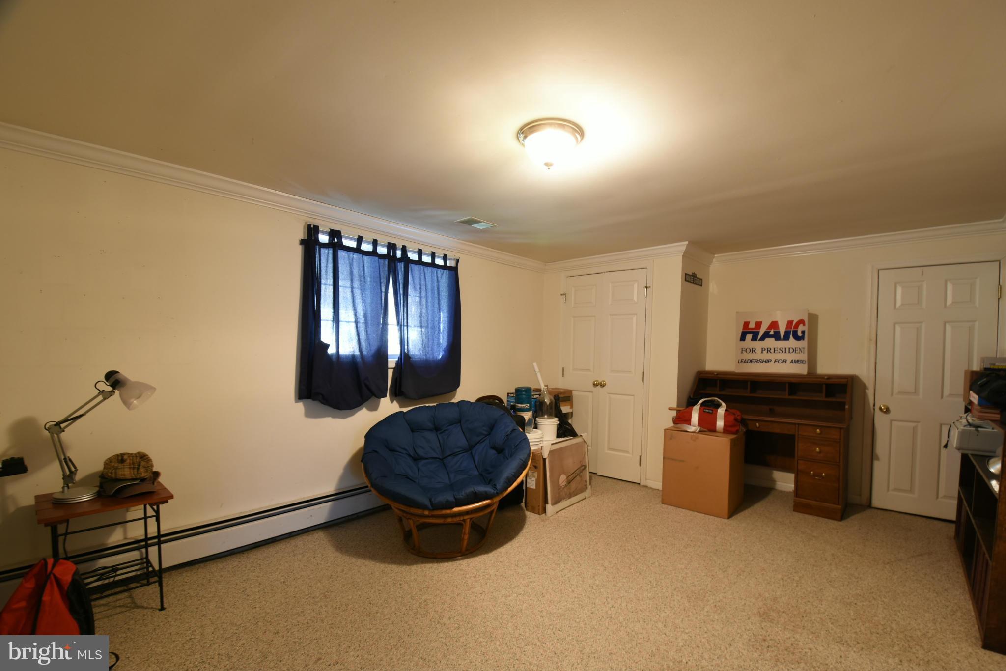 5911 Chesterbrook Road McLean, VA 22101 - Photo 22 of 28 a living room with furniture gym equipment and a window