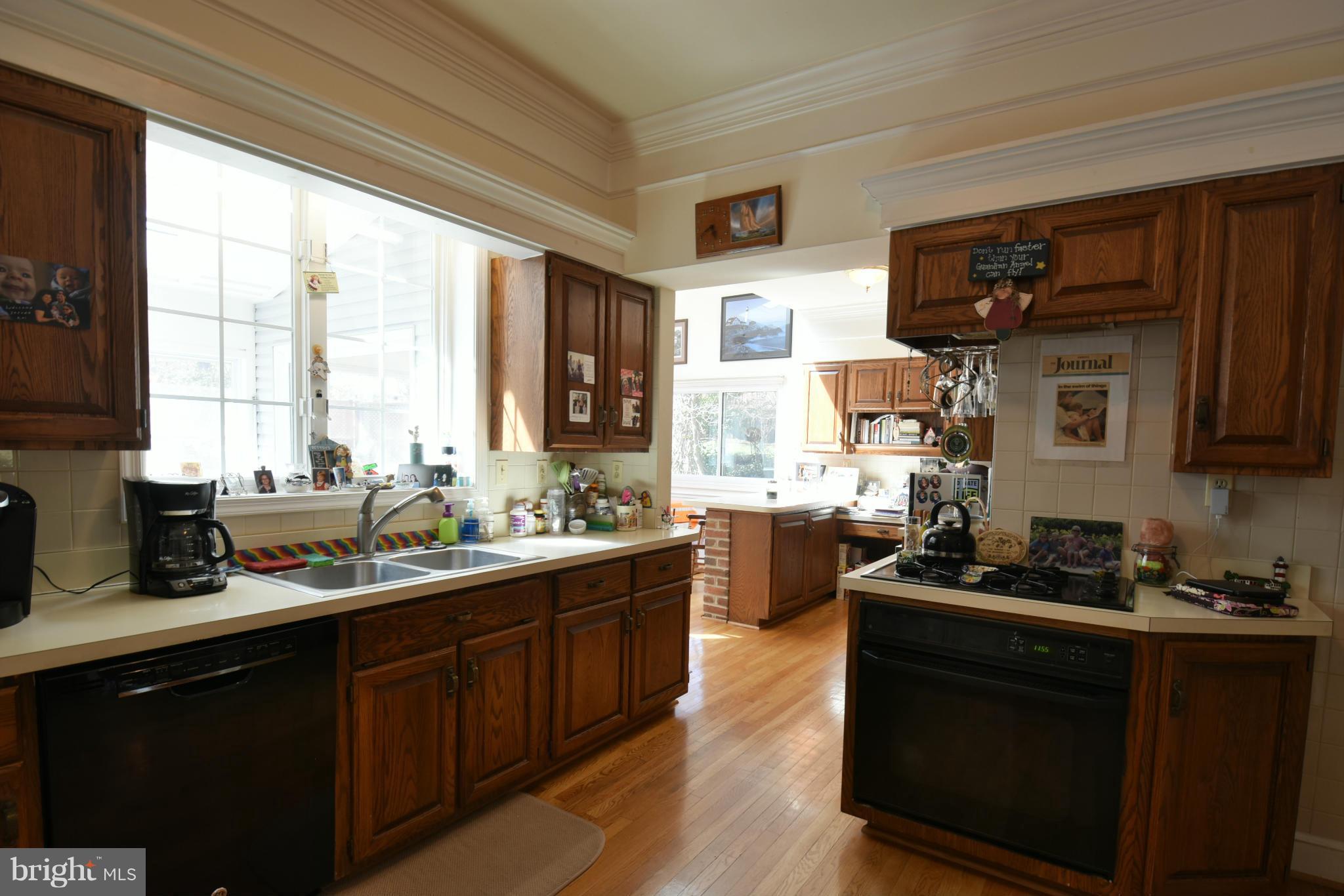5911 Chesterbrook Road McLean, VA 22101 - Photo 6 of 28 a kitchen with a sink stove and microwave