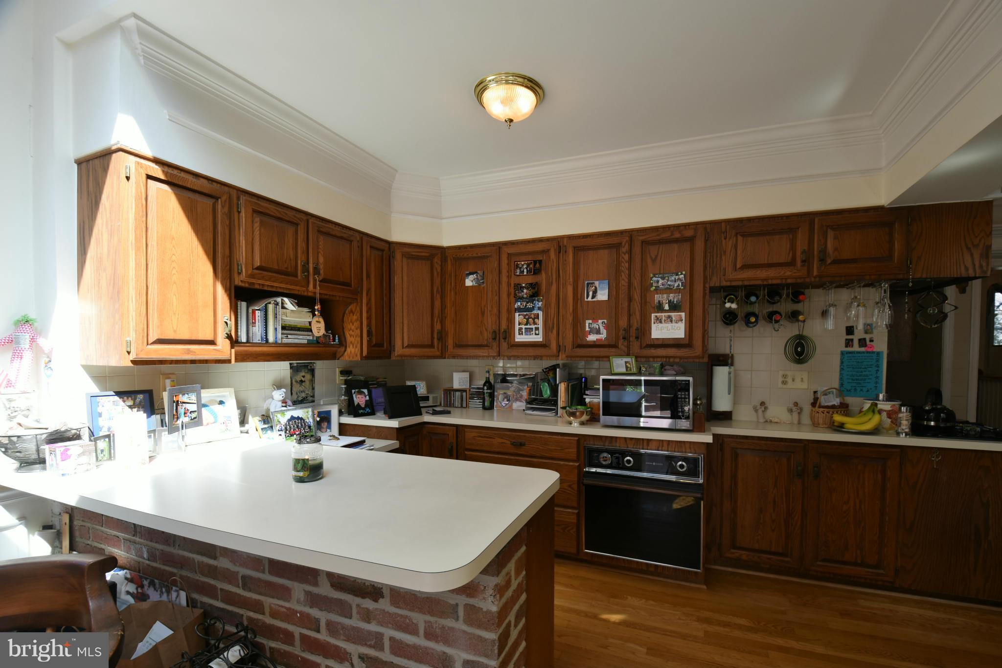 5911 Chesterbrook Road McLean, VA 22101 - Photo 7 of 28 a kitchen with a sink a stove and cabinets