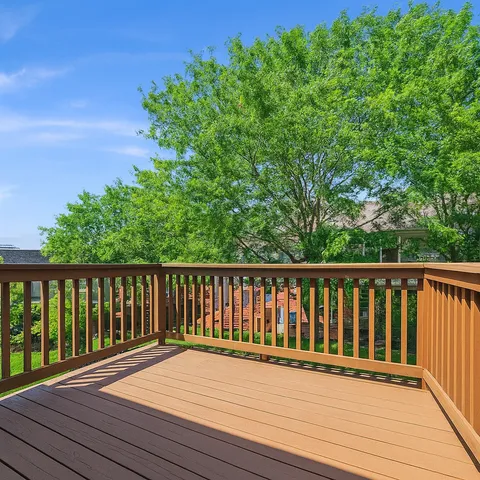a balcony with wooden floor and fence