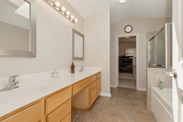 a spacious bathroom with a sink and a mirror