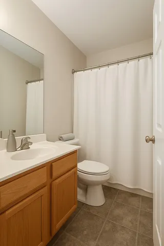 a bathroom with a toilet a sink and a mirror